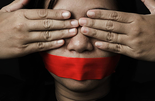 pngtree-red-tape-binding-asian-womans-mouth-in-blindfold-photo-image_34657544